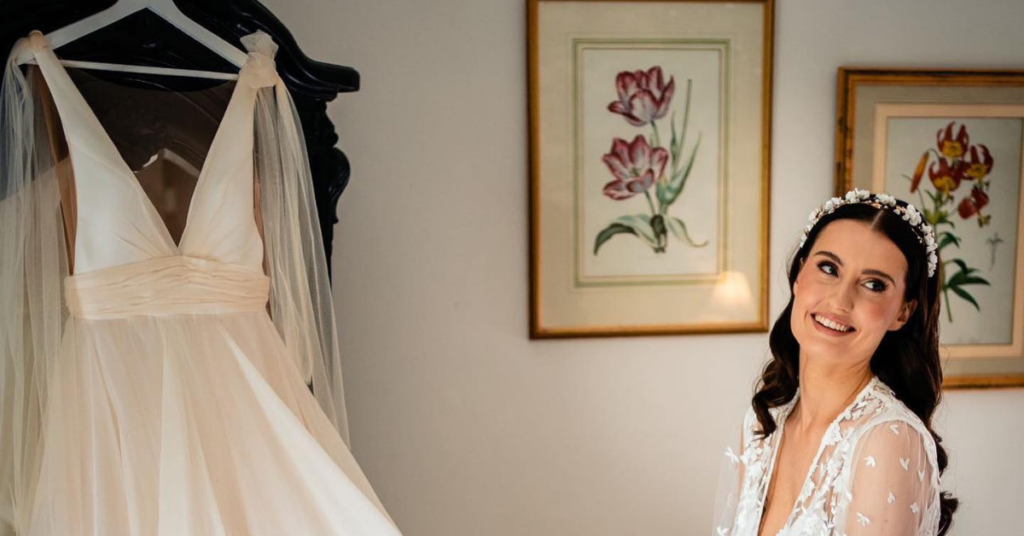 Woman with Wedding Dress on Hanger